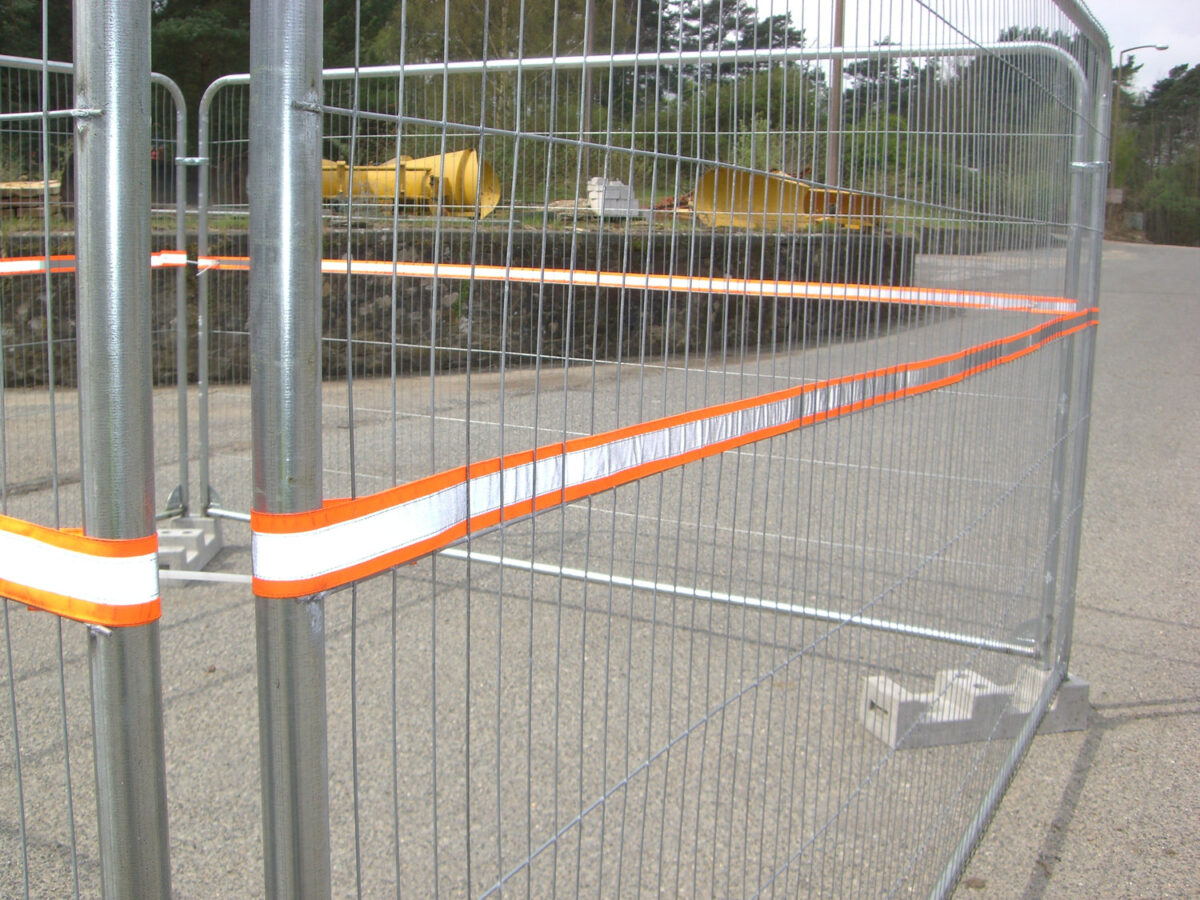 High-visibility reflective strip installed on temporary fencing
