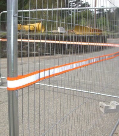 High-visibility reflective strip installed on temporary fencing