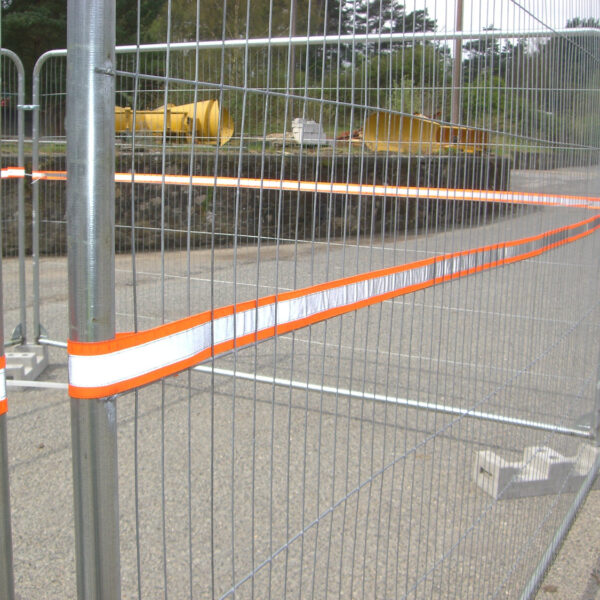 High-visibility reflective strip installed on temporary fencing