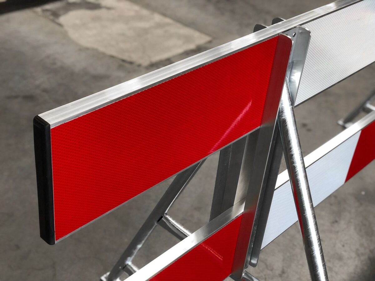 Red and white reflective construction barrier board