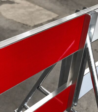 Red and white reflective construction barrier board