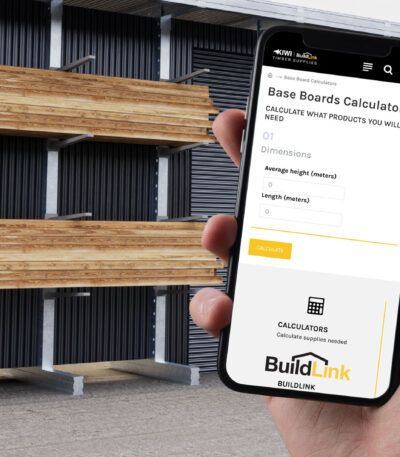 Timber estimating calculator shown on a phone beside stored construction timber